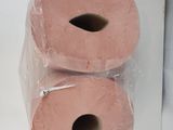 two rolls of pink toilet paper sitting on top of each other