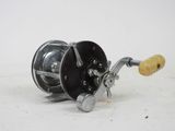 a close up of a fishing reel on a white surface