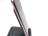 a cell phone that is sitting on top of a stand