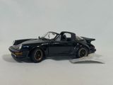 the toy car is black and has gold rims on it