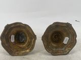 pair of antique brass candlesticks on a white background