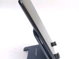 a cell phone on a stand on a white surface
