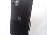 a black iphone sitting on a stand on a white surface