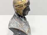 bronze bust of a man with a helmet on his head