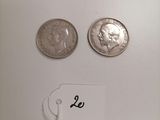 two coins are shown next to each other on a white surface