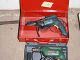 a red box with a drill and a cord in it