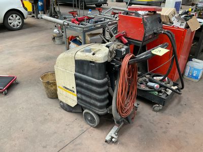 a machine that is sitting on the ground in a garage