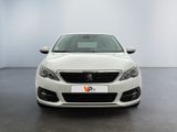 the front view of a white car in a white room