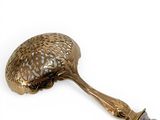a brass spoon with a handle and a handle that has a bird on it