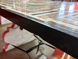 a table that has a tile top on top of it