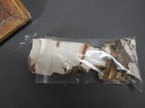 a bag of food sitting on a table next to a picture frame