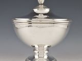 silver plated bowl with lid and spoon on pedestal on grey background