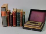 many books that are sitting in a box on the table
