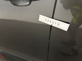 the sticker is attached to the door of a car with a sticker on it