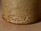 a close up of a brown vase on a table