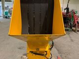 a yellow machine sitting on top of a pallet in a warehouse
