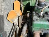a close up of the engine of a green truck