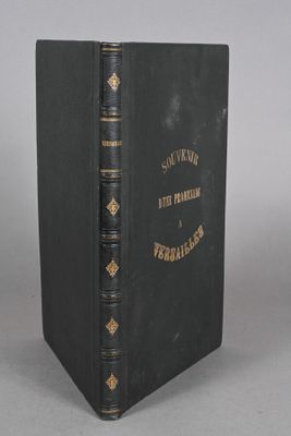 a black book sitting on top of a table next to a white wall