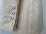 a close up of a sweater with buttons on it