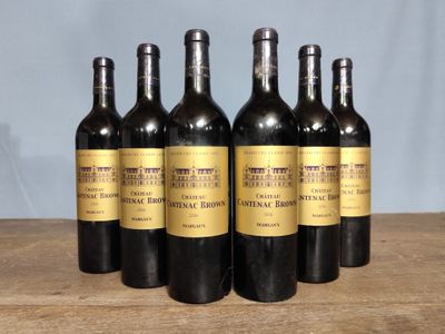six bottles of wine sitting on top of a wooden table