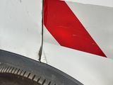 a red and white stripe on the side of a white van