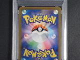 a close up of a pokemon card in a plastic case
