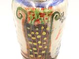 a vase that is sitting on a white surface