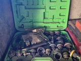 a green tool box with a bunch of tools inside of it