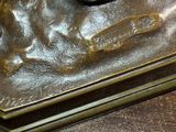 a bronze statue of a dog on a table