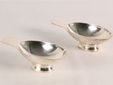 pair of silver plated salt and pepper shakers on a white background
