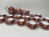 many cups and saucers that are sitting on a table