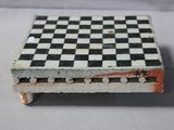 a black and white chess board on a small table