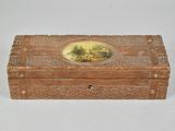 a small wooden box with a painting on it
