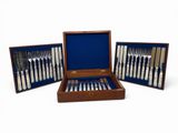 a set of silverware in a wooden case