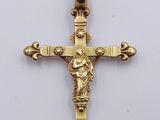a close up of a cross on a table with a white background