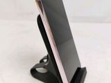a cell phone that is on a stand on a table