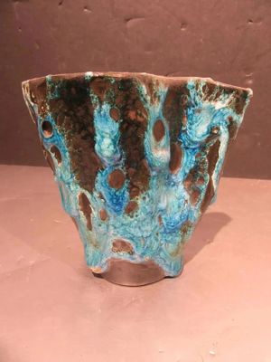 a blue and brown bowl sitting on a table