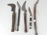several different types of knives are displayed on a white surface