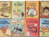 several children ' s books are lined up on a white surface
