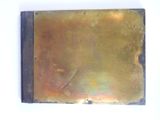 a picture of a metal plaque on a white wall