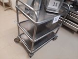a metal cart that has three trays on top of it