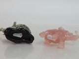 two figurines that are sitting next to each other on a table