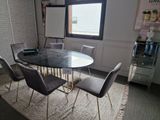 a table and chairs in a room with a large window