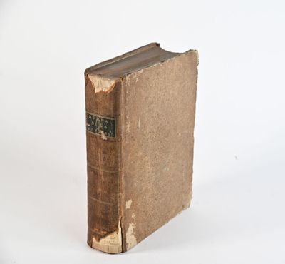 an old book sitting on top of a white table