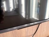 a flat screen tv sitting on top of a wooden table
