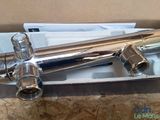 a picture of a chromed faucet in a cardboard box