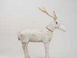 sculpture of a white deer with antlers on it ' s head