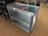 a metal table with a basket on top of it