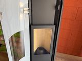 a small refrigerator with a door open on a wooden floor