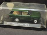 a green toy car in a clear box on a table